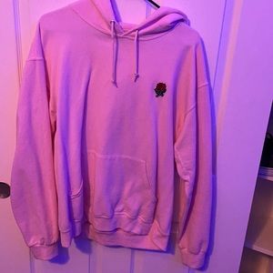 Pink hoodie with rose on it.